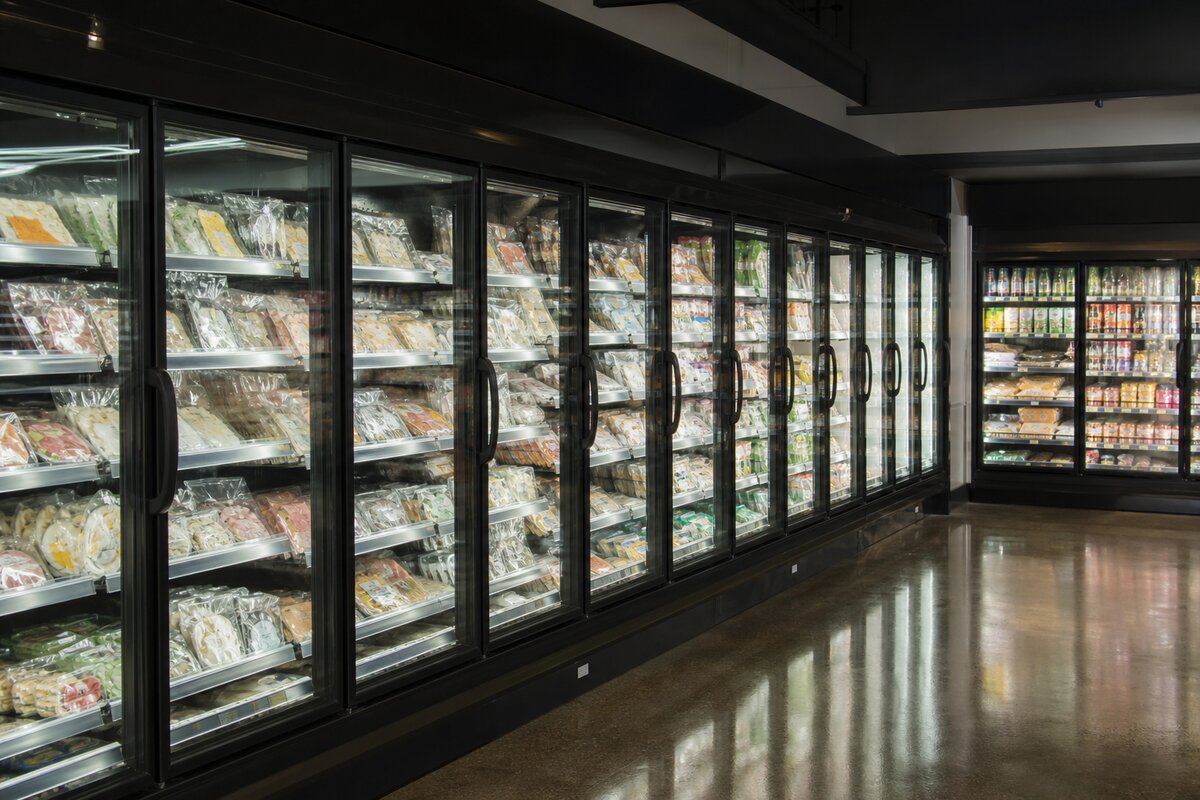 Commercial retail refrigeration cases and cold display units in a grocery store aisle