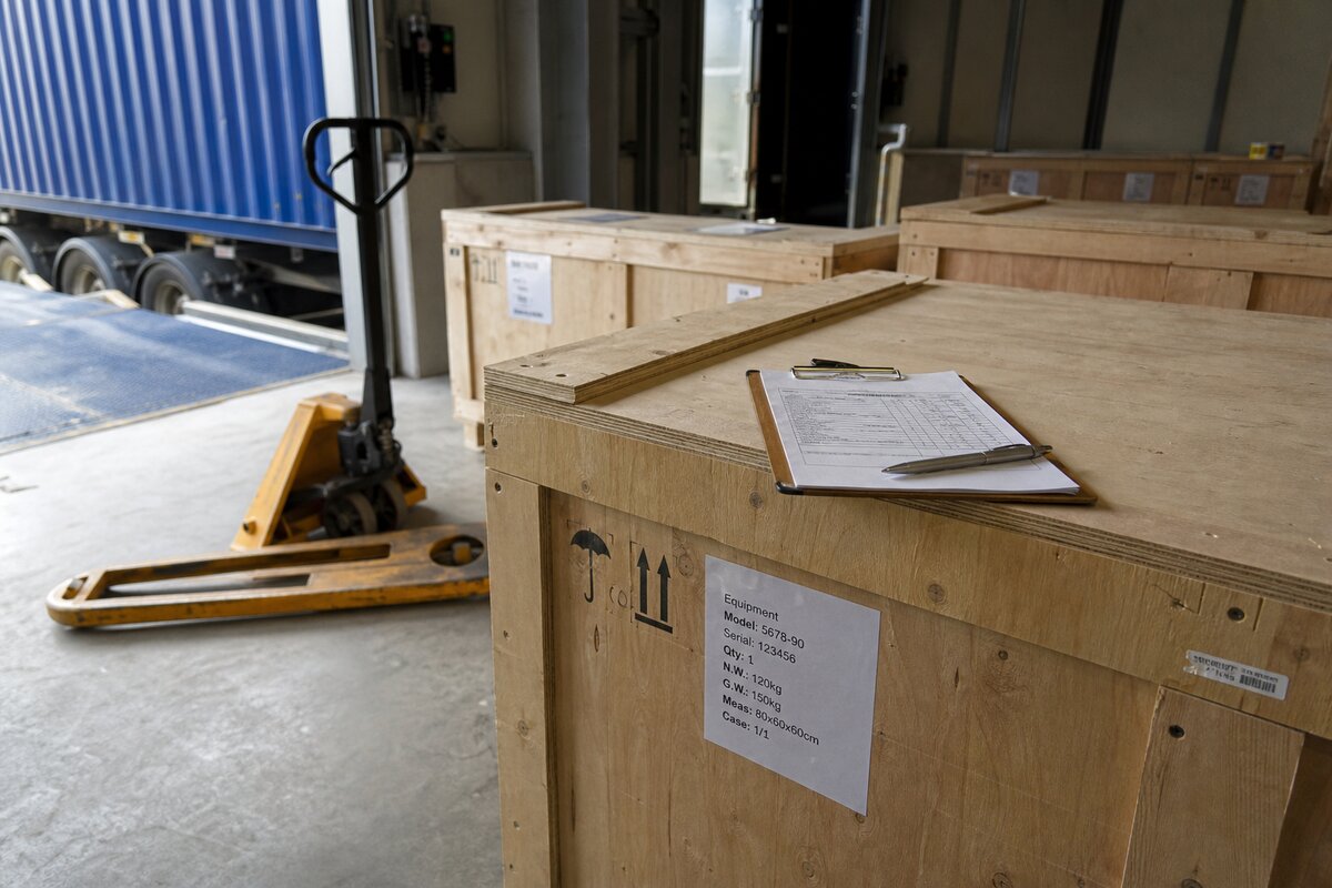 Warehouse receiving dock with new equipment crates ready for intake